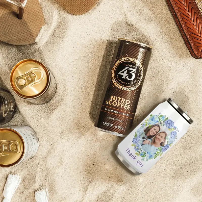 Can of Licor 43 Nitro Coffee liqueur next to Blooming Caffeine stainless steel coke cups travel mug