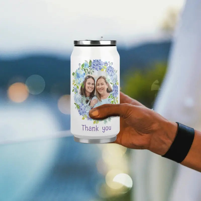 Hand holding a personalized floral Coke cup, perfect for travel and casual vibes