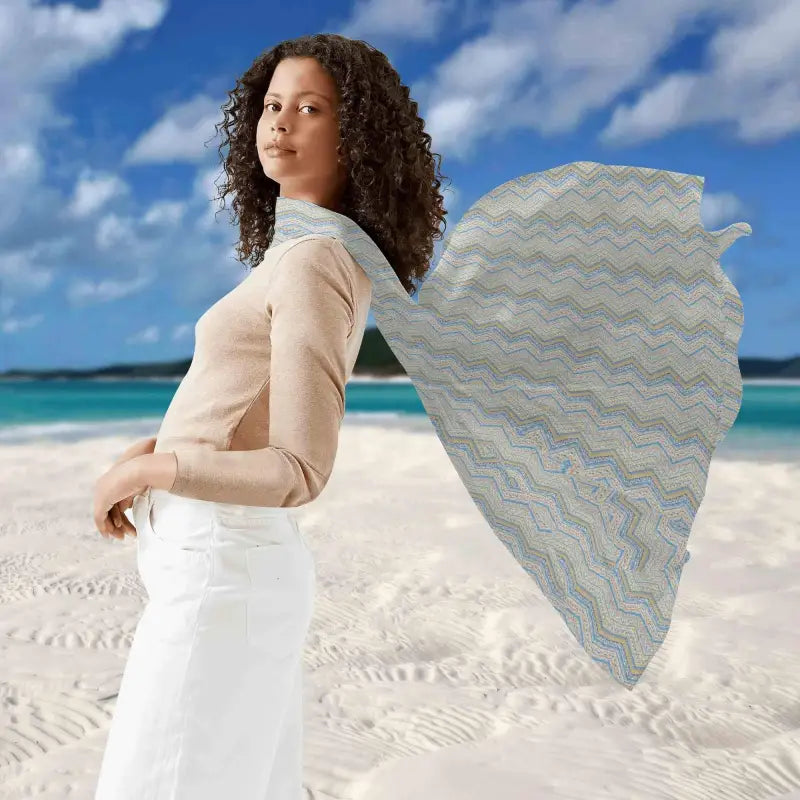 Woman rocking a beige top and white pants with a Blue Boho Print sarong on the beach