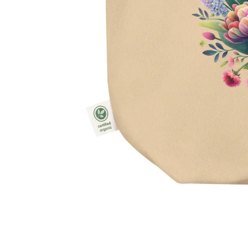Beige floral tote bag featuring a vibrant design and green certification label