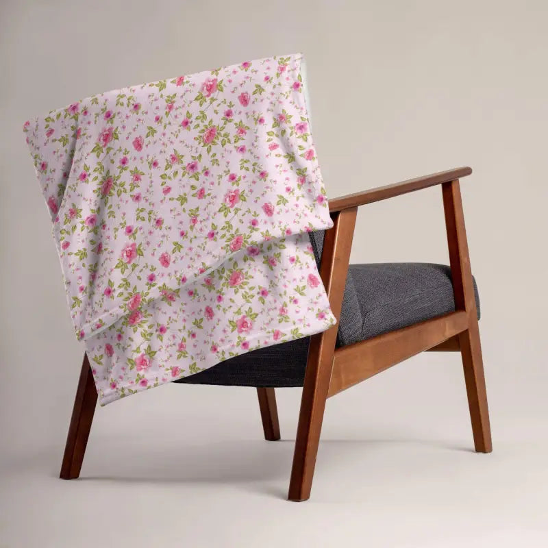 Mid-century modern armchair with warm rose floral sherpa throw draped elegantly