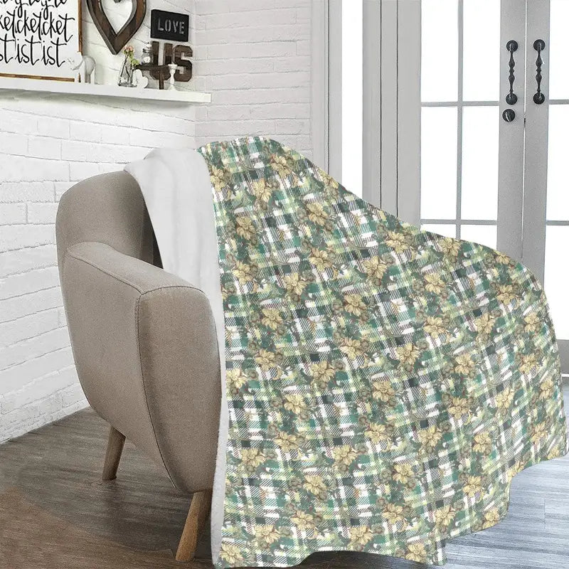 Cozy Green Plaid Floral Ultra-Soft Micro Fleece Blanket draped over a chair
