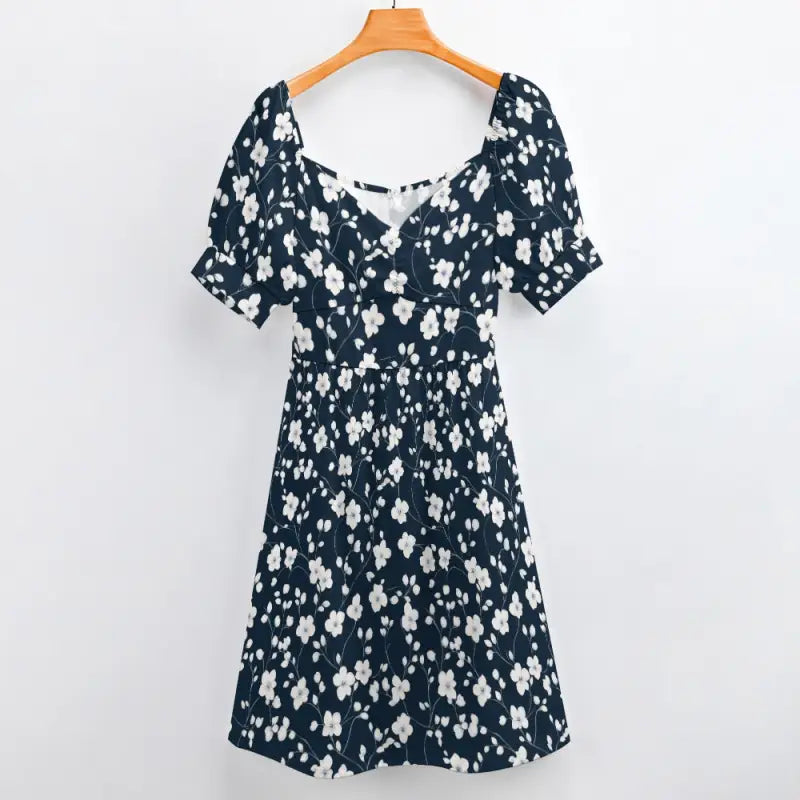 Navy floral sweetheart dress with puffed sleeves hanging on an orange hanger