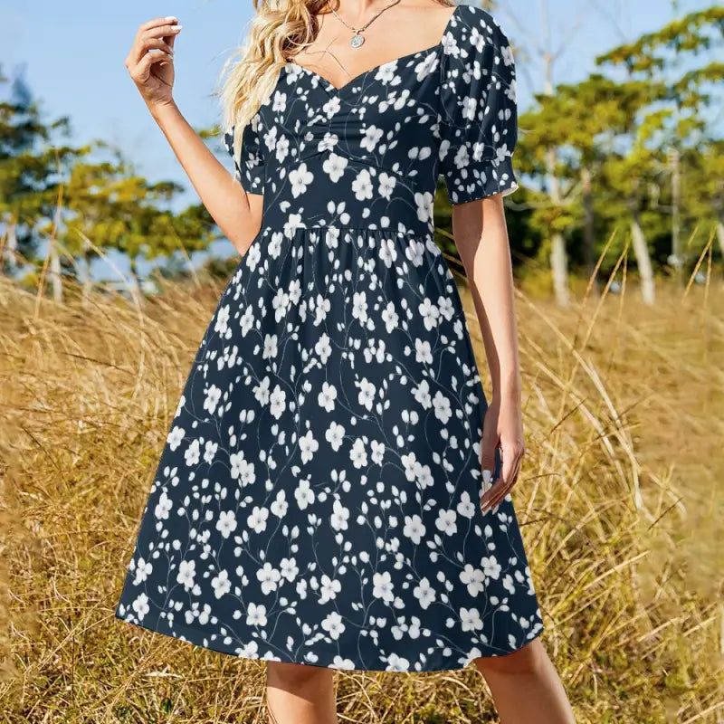 Navy blue floral sweetheart dress with puff sleeves and knee-length skirt, enchanting floral design