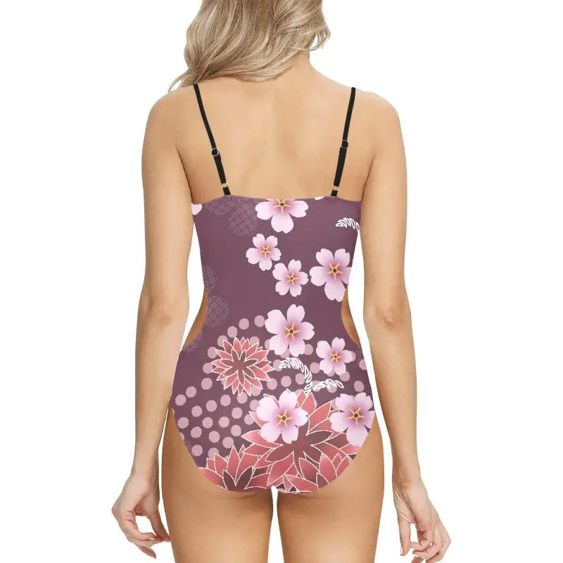 Floral print one-piece swimsuit with thin straps on a purple background for stylish fun