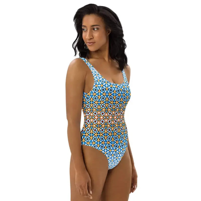 Woman in a colorful geometric tank style one-piece swimsuit, showing off beach vibes