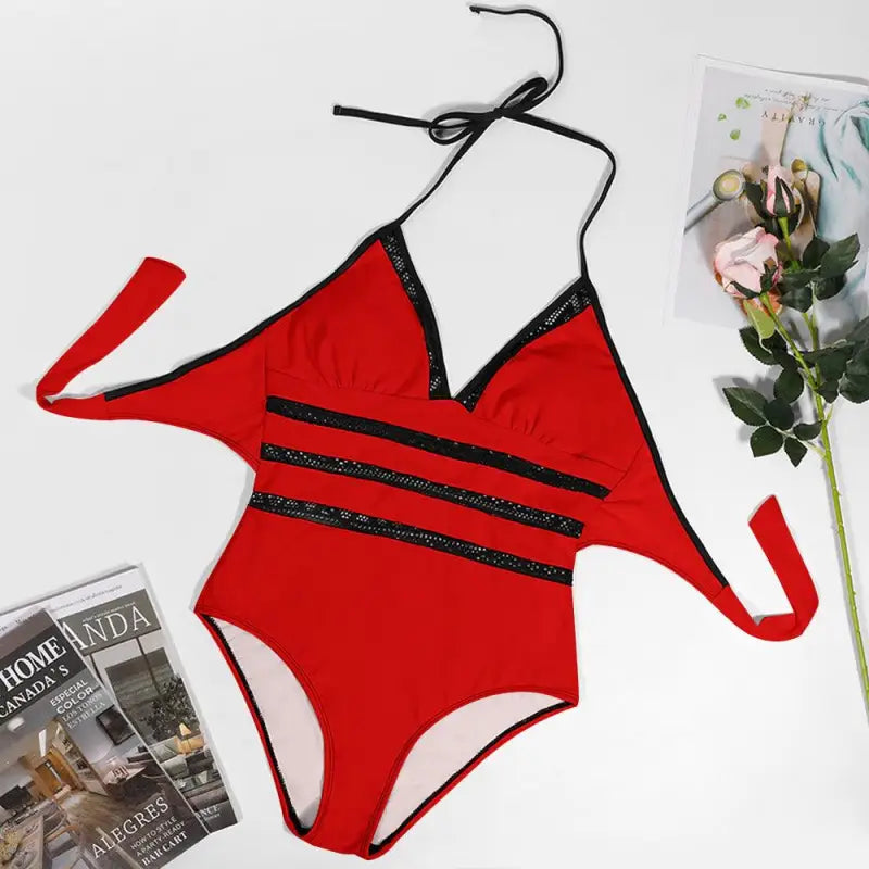 Red one-piece swimsuit with black stripes and halter neck for vibrant lace inset tie look