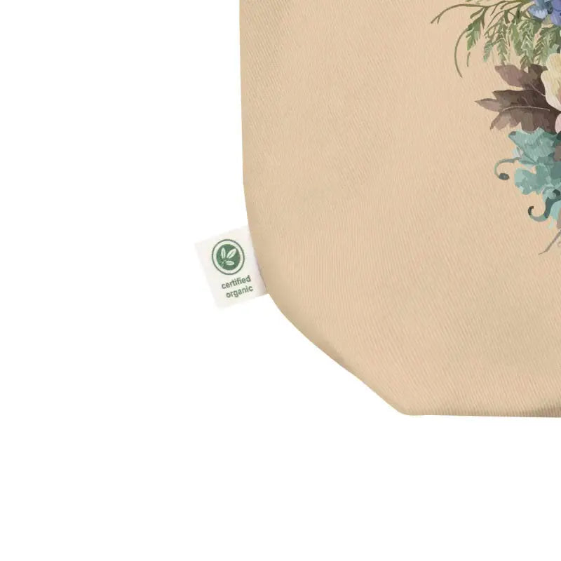 Beige fabric eco tote featuring floral butterfly design and green certification label