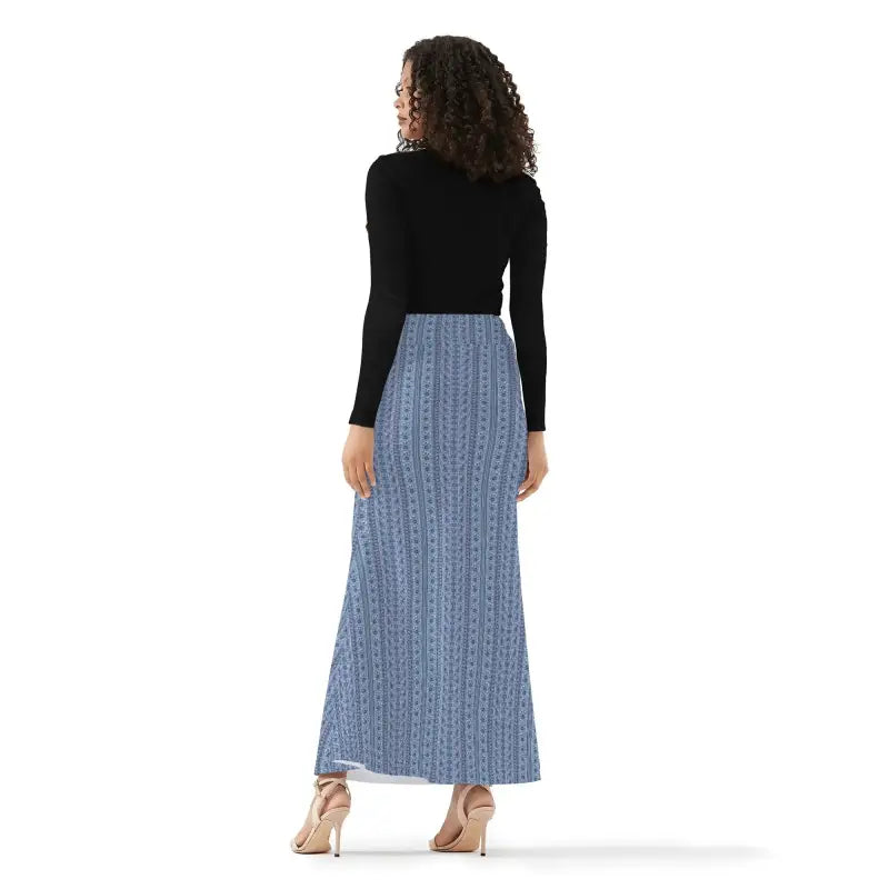 Woman in a black top and blue patterned boho maxi skirt, showcasing high-waisted design