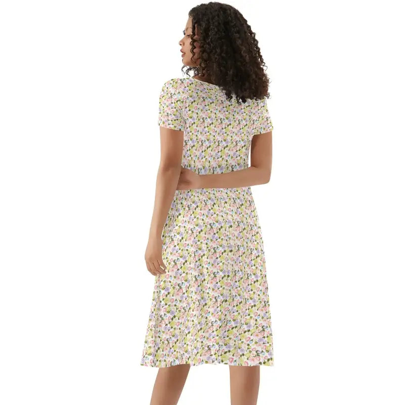 Woman with curly hair rocking a floral print womens short sleeve ruffle dress