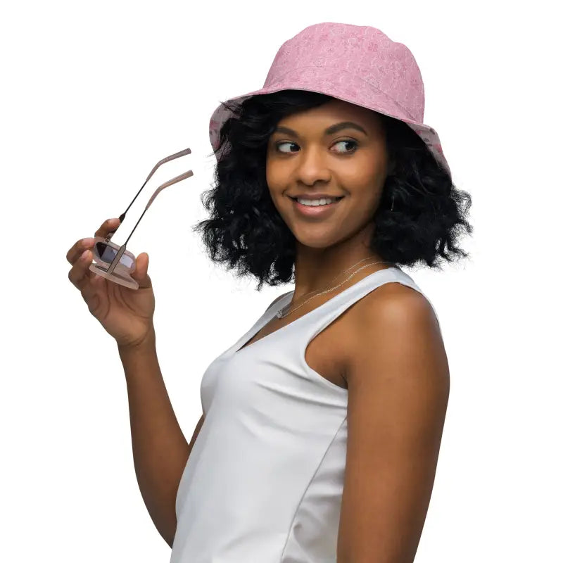 Woman in a pink hat and sunglasses rocking a women’s floral reversible bucket hat