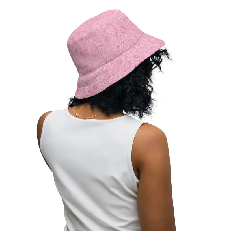 Person with curly dark hair rocking a women’s floral reversible bucket hat in pink