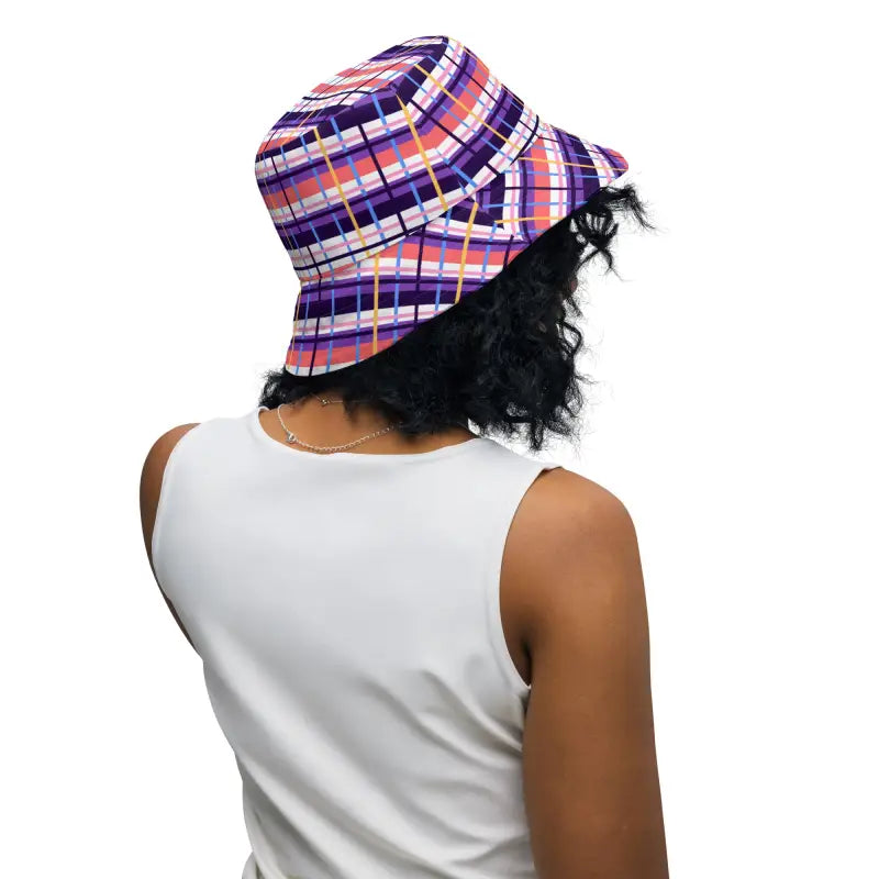 Colorful plaid floral reversible bucket hat stylishly worn by a person with curly hair