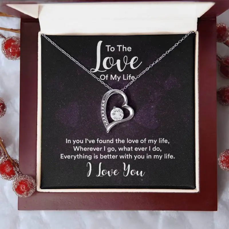 Heart-shaped love necklace with romantic message on a gift box in yellow gold finish