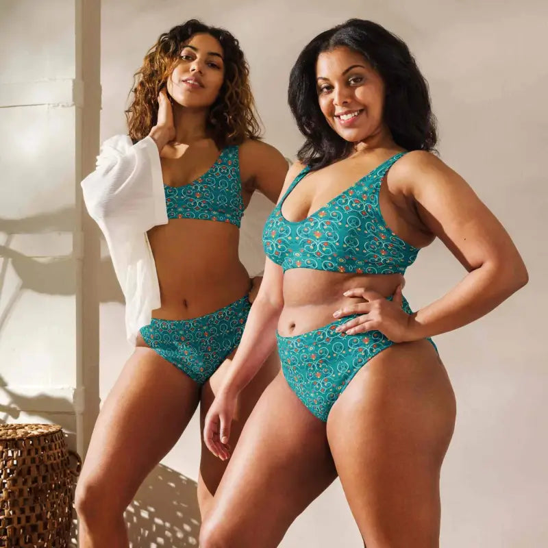 Two women in stylish teal blue geometric print high-waisted swimsuits ready for fun