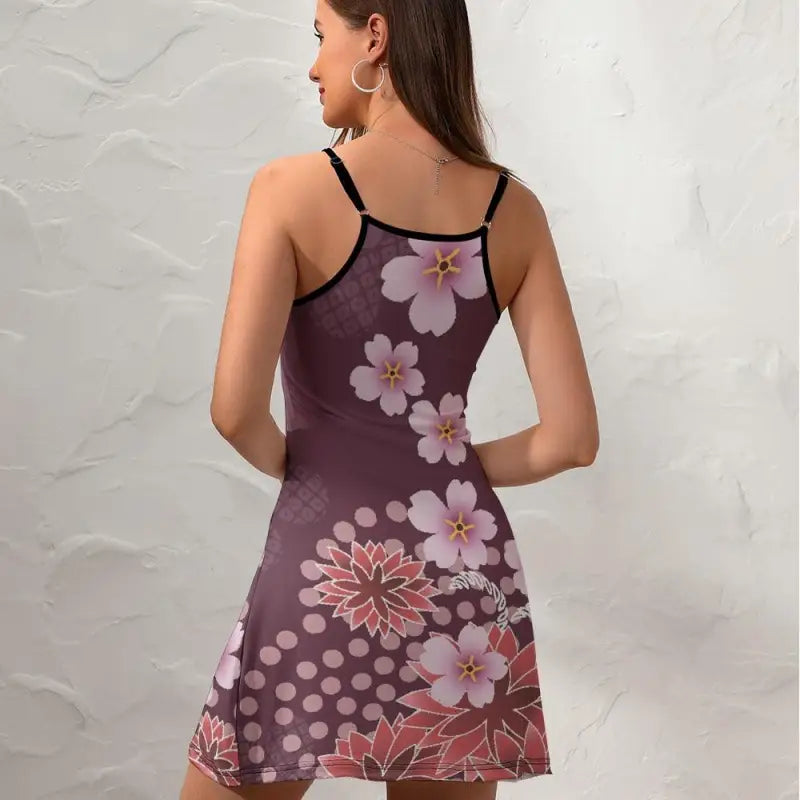 Floral slip dress with thin straps against a purple abstract floral background