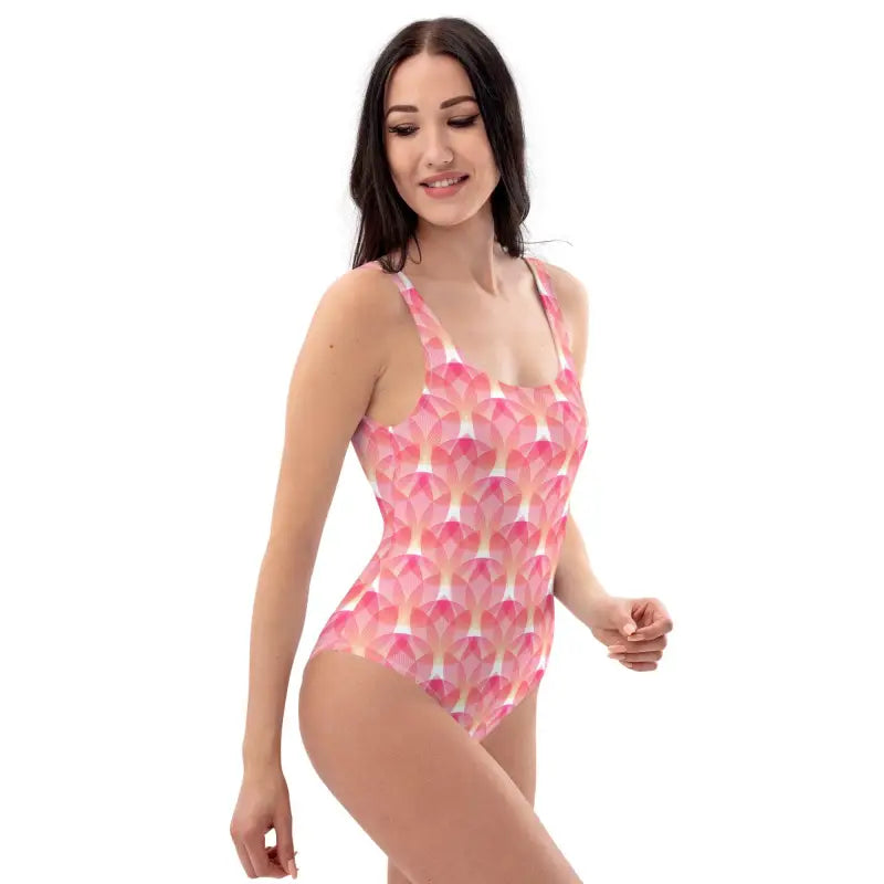 Woman rocking a pink geometric print one-piece swimsuit at the beach