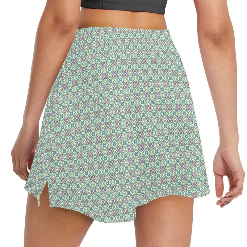 Stylish patterned mini skirt with slits in green, blue, and white geometric floral print