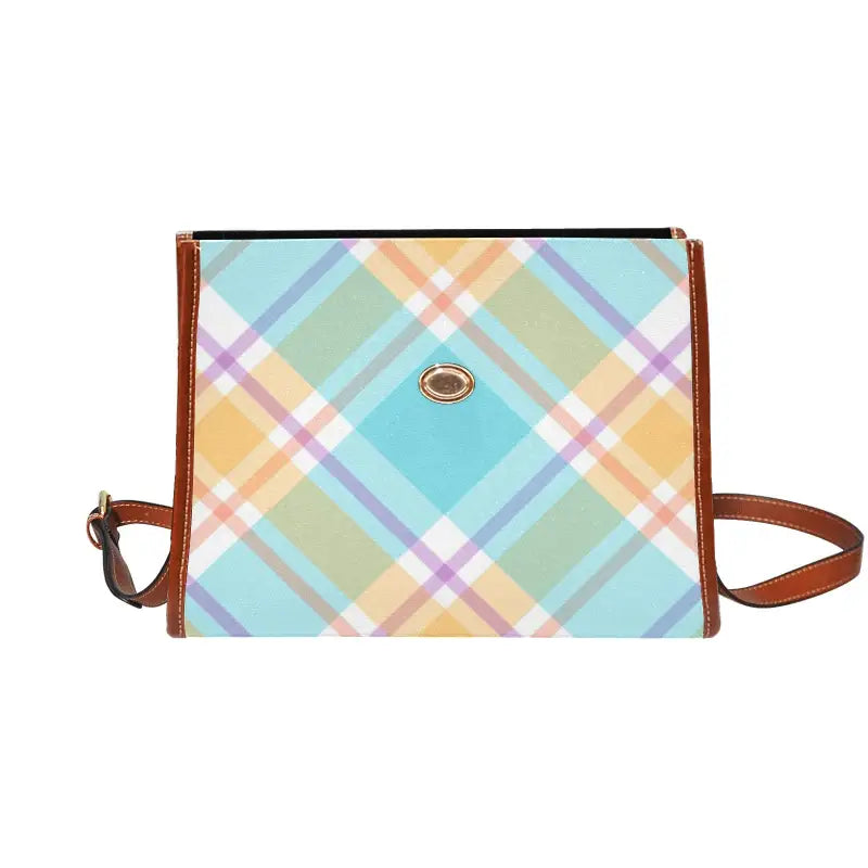 Stylish blue plaid handbag with brown leather trim, perfect for women’s fashion