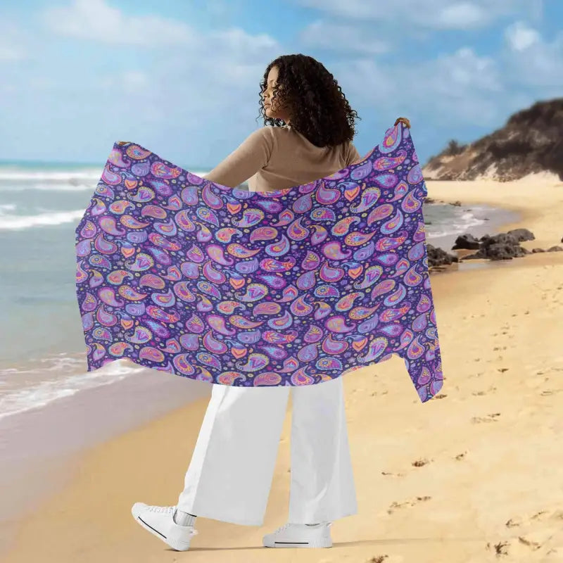 Colorful beach towel featuring a vibrant purple paisley sarong wrap for women