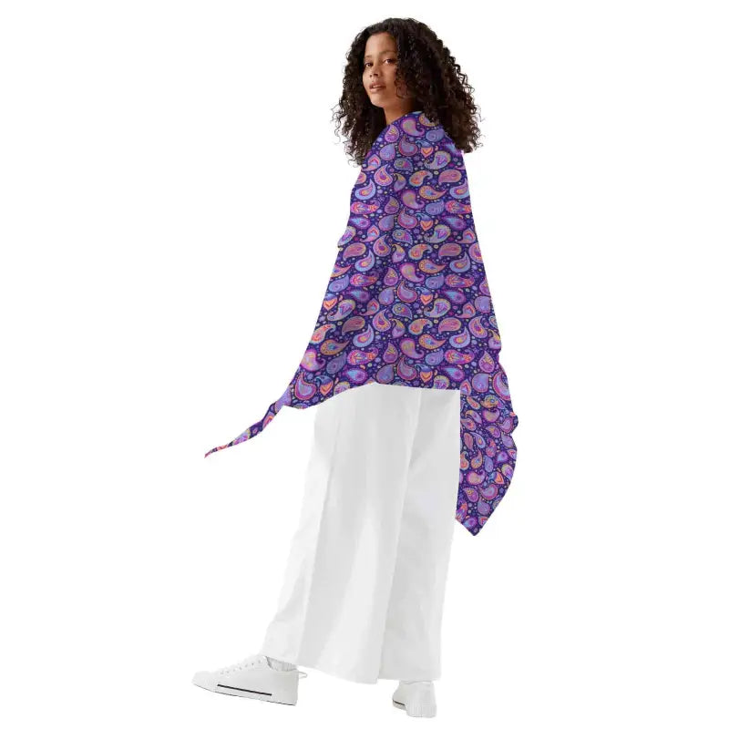 Colorful women’s purple paisley sarong wrap styled over white clothing for a trendy look