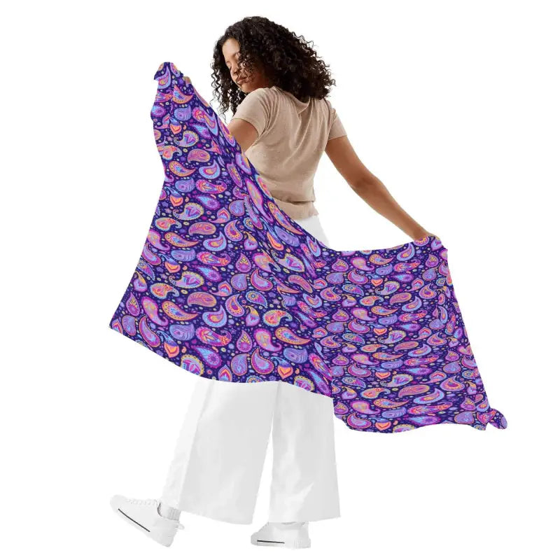 Colorful purple paisley sarong held up to show off its stylish design and vibrant pattern