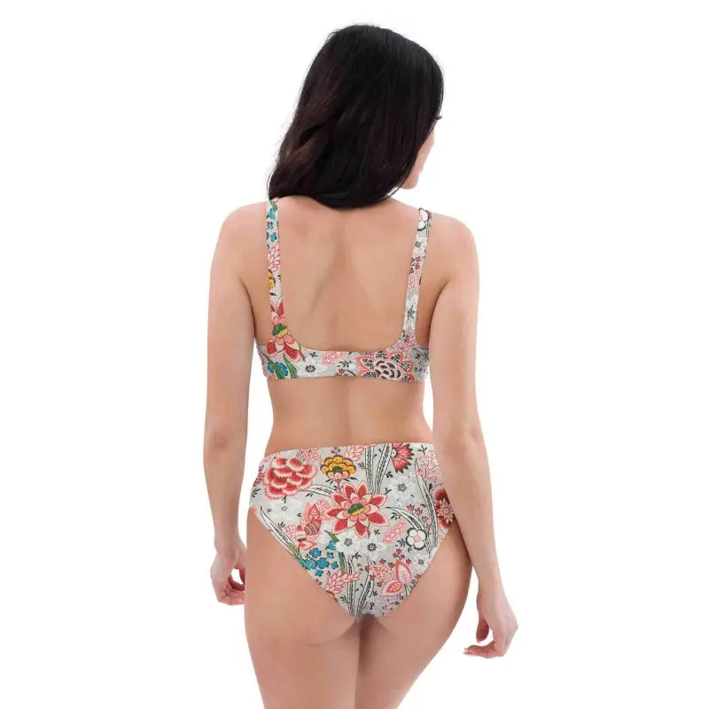 Woman in a retro floral high-waisted bikini, showing off that beach vibe from behind