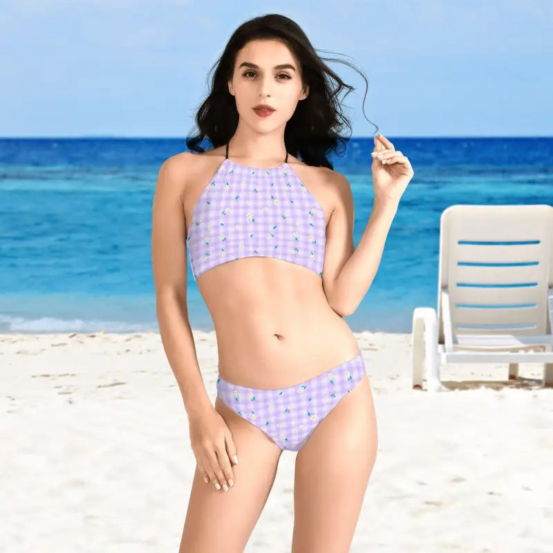 Woman in a lavender floral pattern bikini soaking up sun at the beach