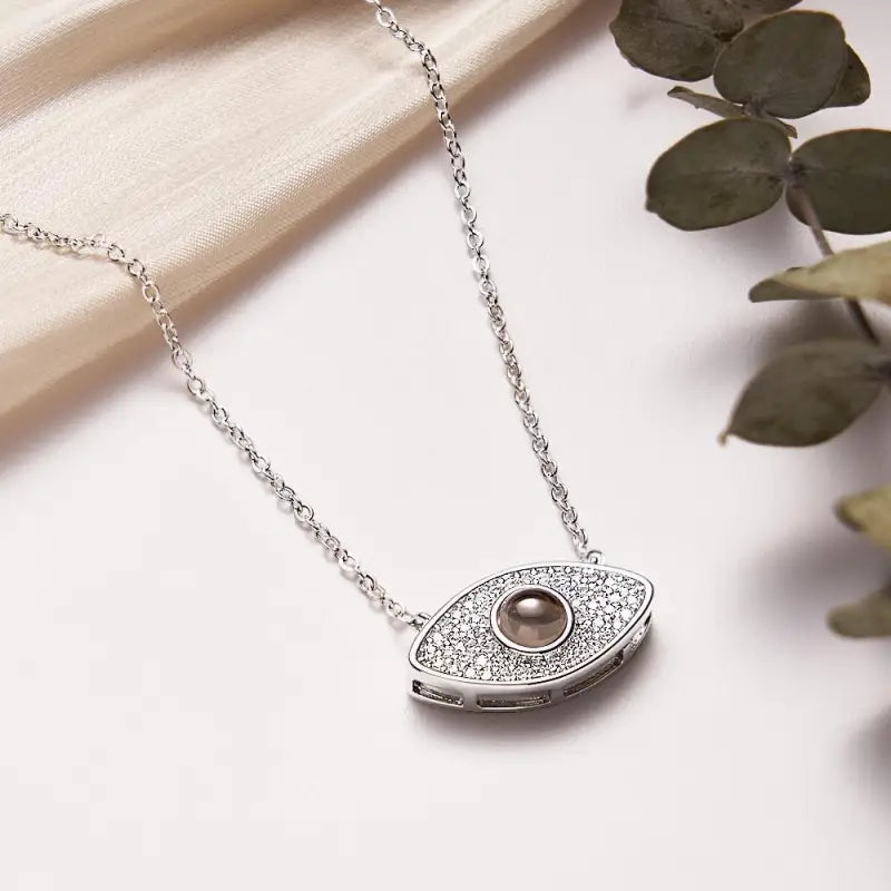 Eye-shaped gemstone silver necklace for stylish evil eye projection fashion