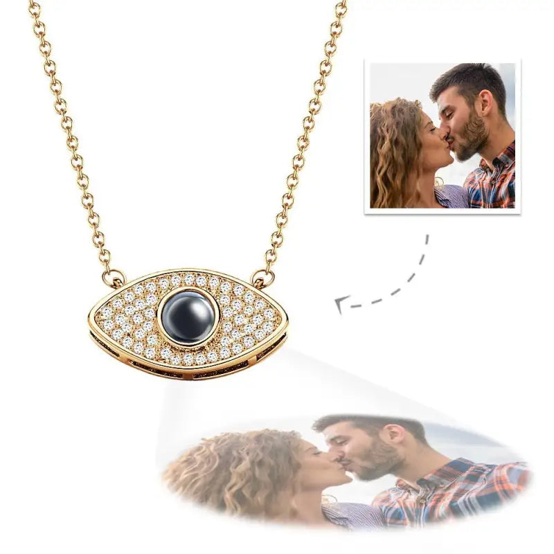 Gold evil eye projection necklace with diamonds and a stunning dark gemstone