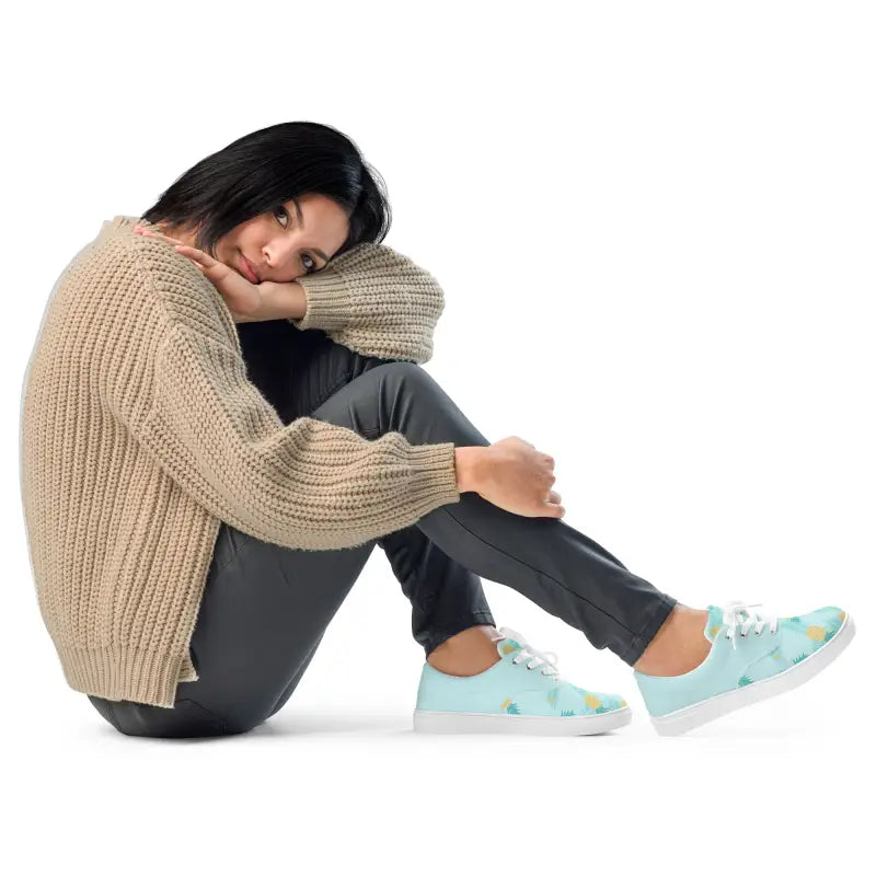 Woman in a beige sweater and mint green sneakers showing off Women’s Pineapple Lace-Up