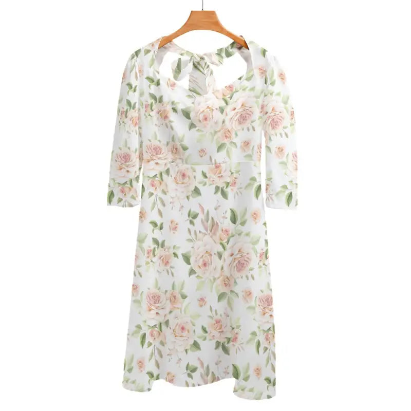 Floral print dress with three-quarter sleeves on hanger, featuring a rose print sweetheart neckline