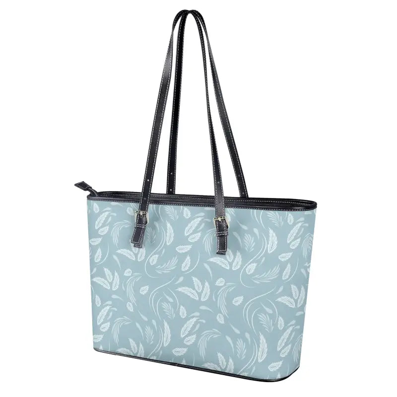 Light blue floral shoulder tote bag with white feather pattern and black leather handles