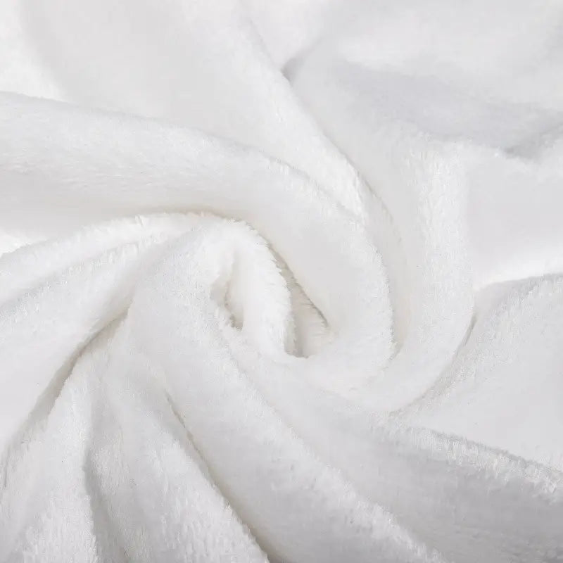 Soft white fabric with gentle folds on a premium fleece blanket perfect for Christmas snuggles