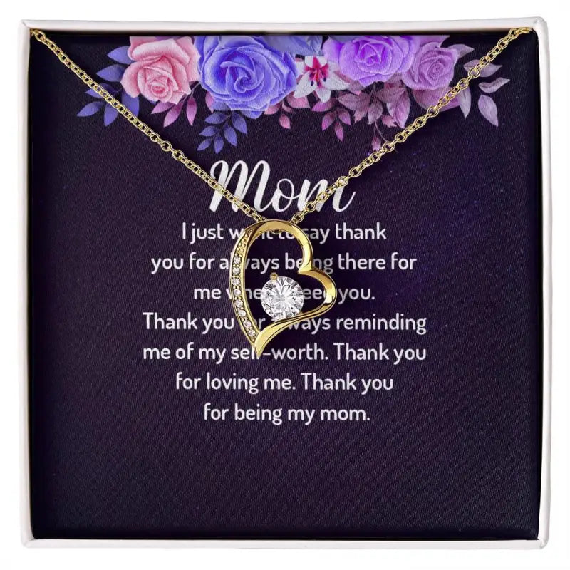 Gold Mom pendant necklace with heart charm against flowers, perfect forever love heart gift