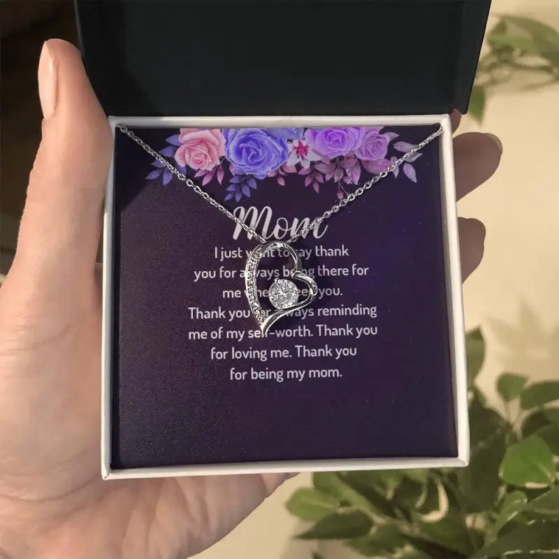 Heart-shaped love heart necklace with ’Mom’ in a floral gift box, yellow gold finish