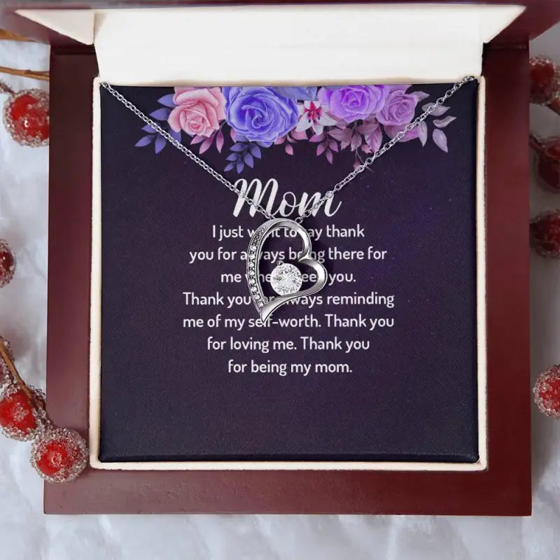 Mom’s Forever Love Heart Necklace features a ’Mom’ pendant on a floral card