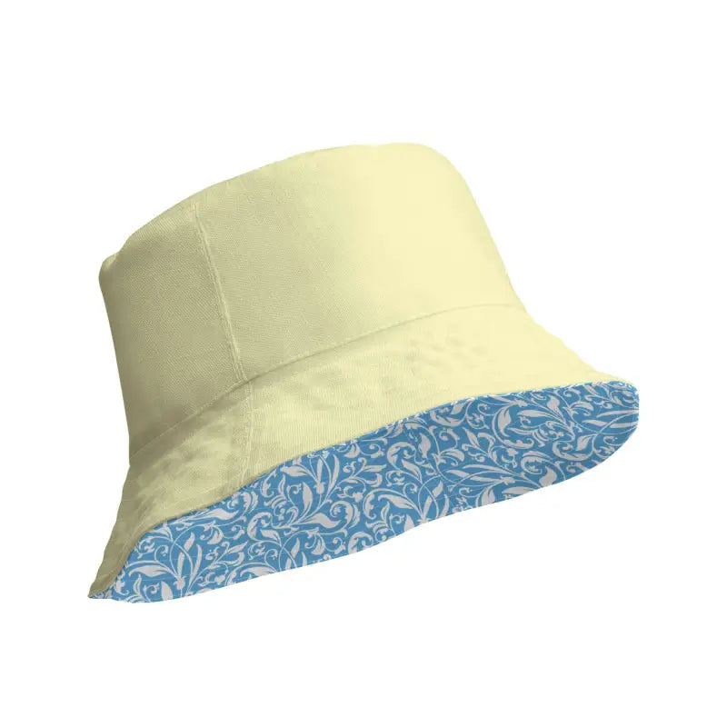 Pale yellow reversible bucket hat with blue floral patterned underside for sunny vibes