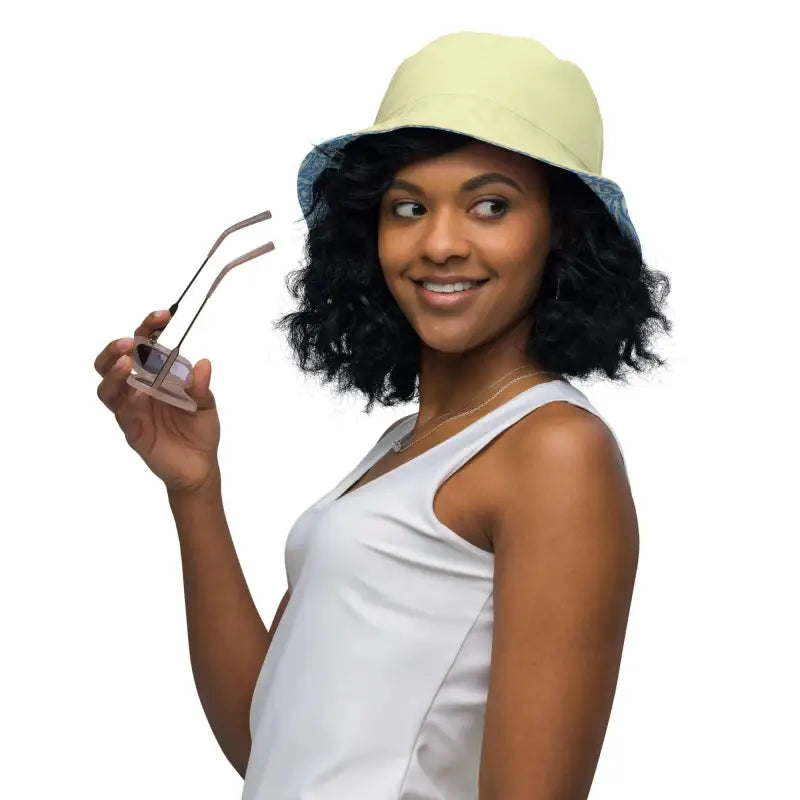 Smiling woman in a pale yellow Floral Reversible Bucket Hat and white tank top