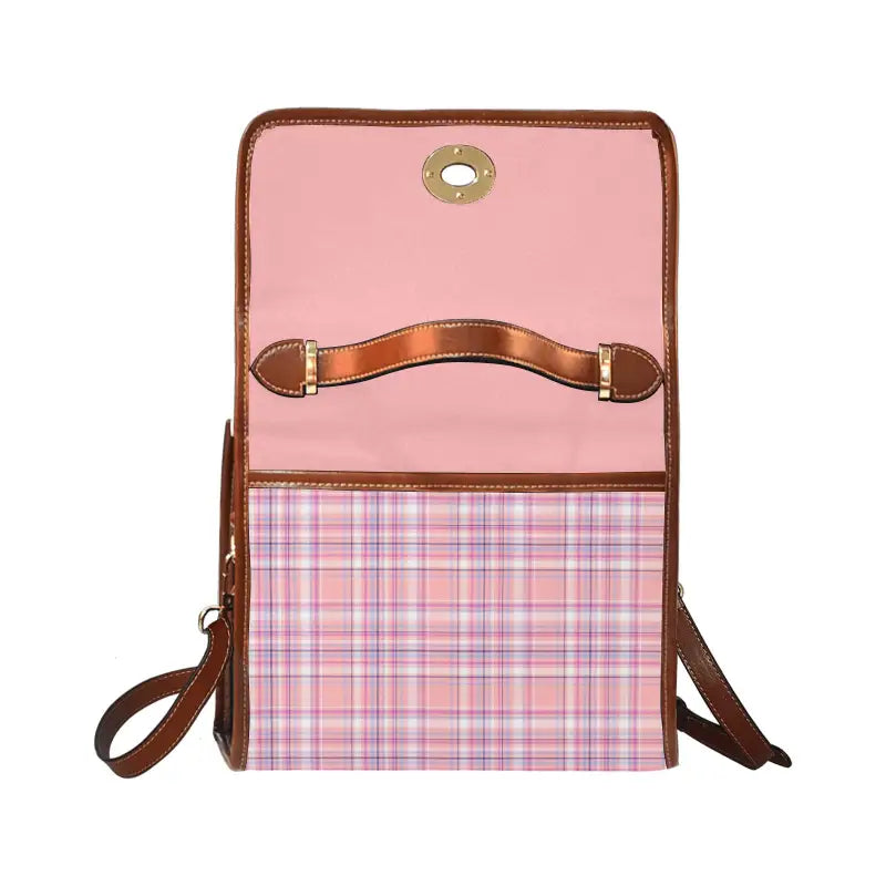 Pink and plaid messenger bag with brown leather trim for effortlessly carrying style vibes