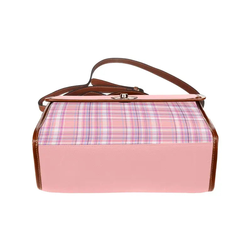 Pink and plaid handbag with brown leather trim, perfect for effortlessly carrying peach plaid canvas style