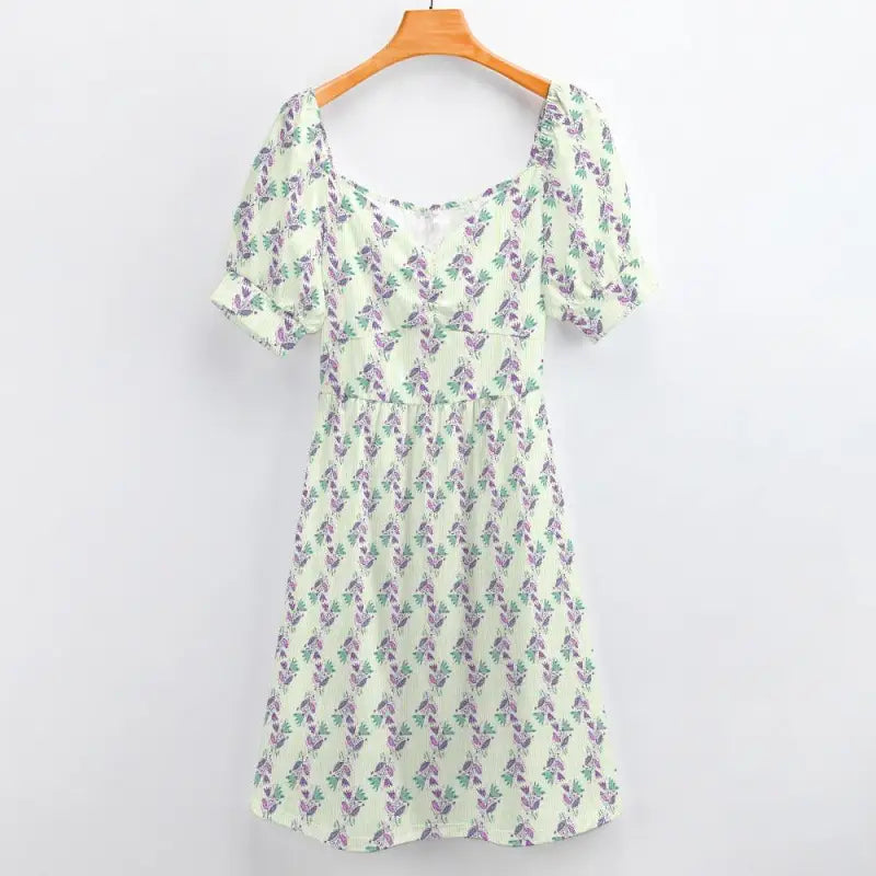 White floral sweetheart dress with puff sleeves hanging on an orange hanger
