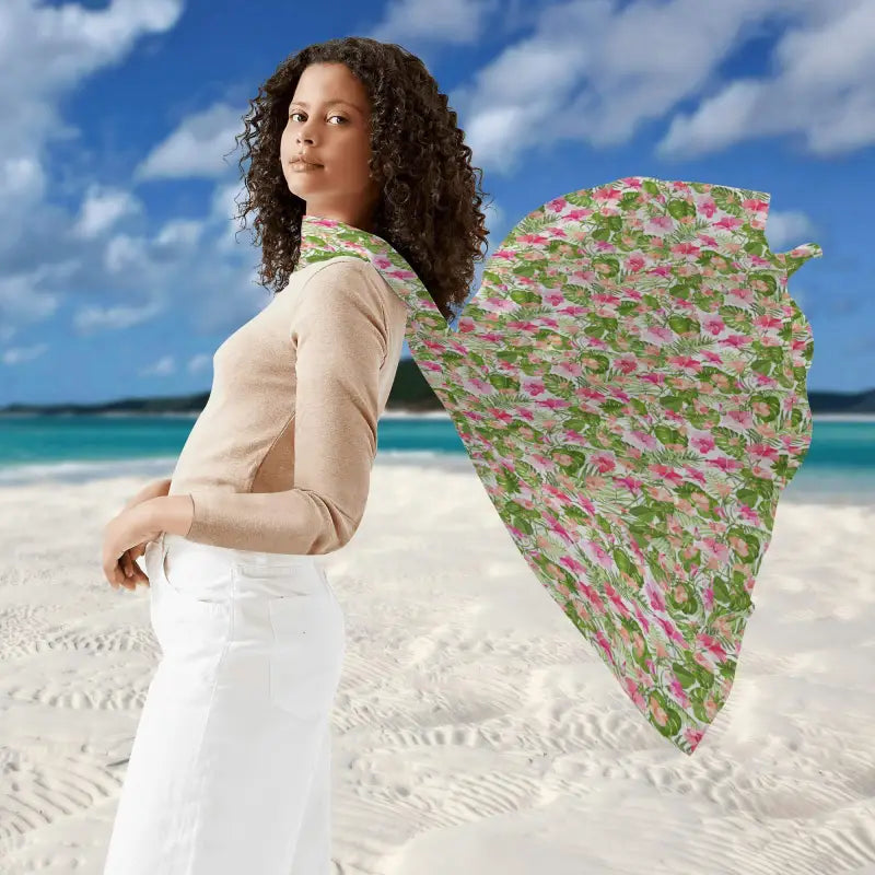 Woman in curly hair rocks a beige top and white pants, showcasing tropical Hawaiian style