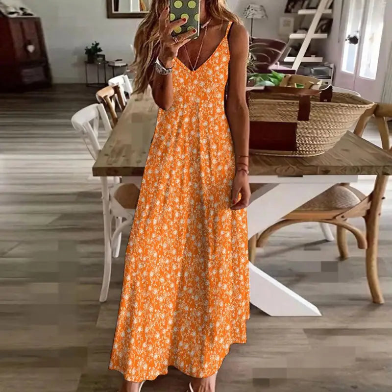 Bright orange floral ankle maxi dress with straps and a flowing skirt for stylish vibes