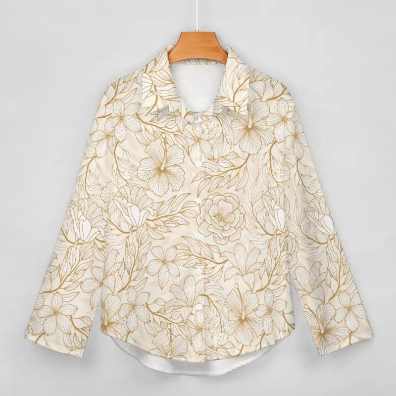 Floral patterned women’s gold floral print shirt on a wooden hanger for a party-ready look