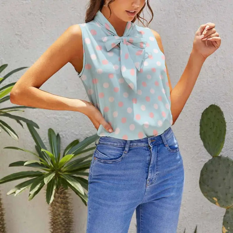Sleeveless light blue blouse with pink polka dots and tied collar for women’s blue polka dot style