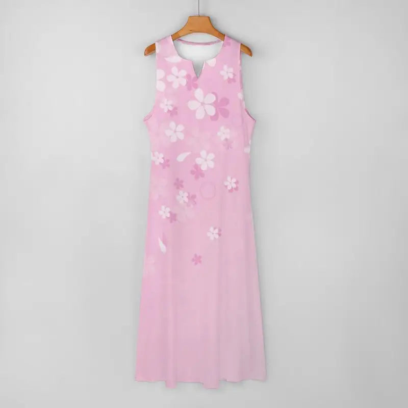 Pink floral sleeveless dress with white appliqués hanging on a hanger for style lovers