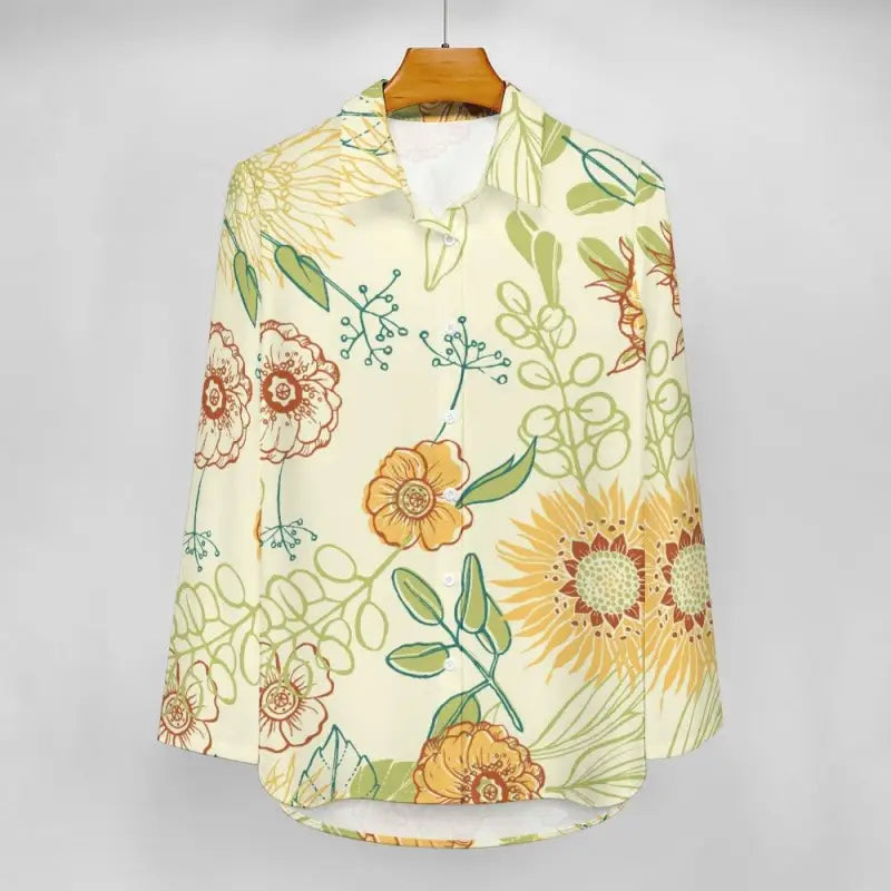 Floral-patterned women’s yellow floral blouse hanging on a wooden hanger