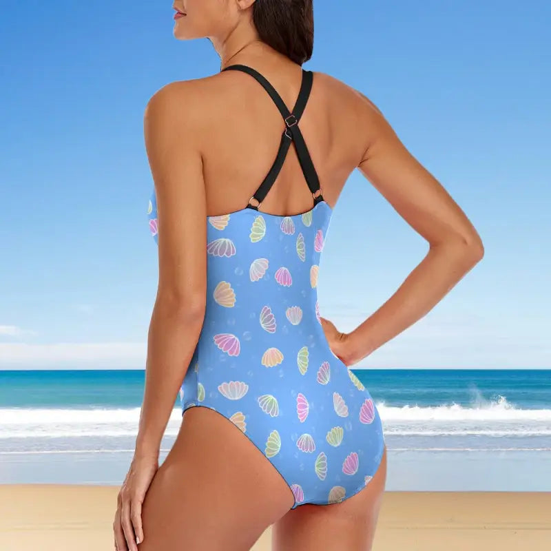 Light blue one piece swimsuit with criss cross back and charming shell pattern