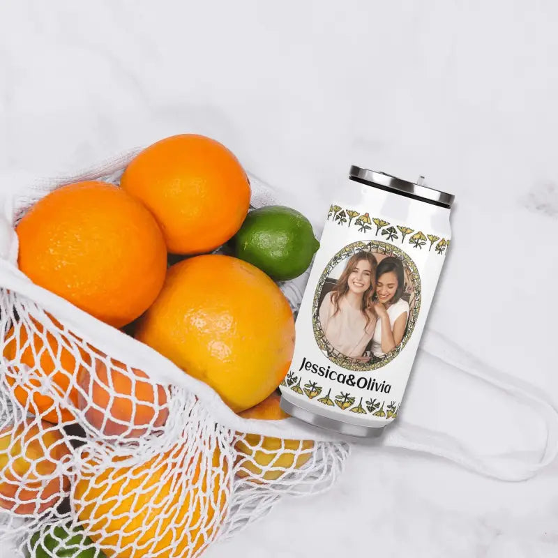 Reusable personalized stainless steel tumbler with pictures beside citrus fruits